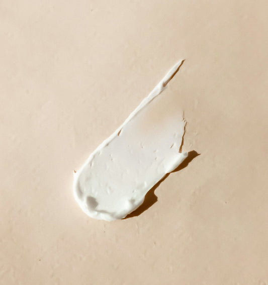 white cream smear on beige surface