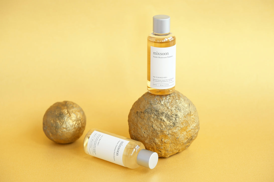 Skincare products are displayed on a gold surface.