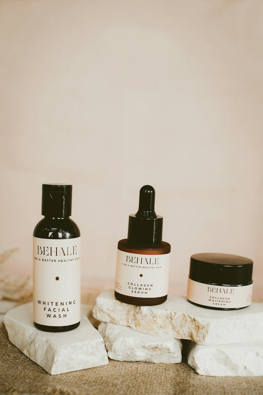Skincare products are displayed on a stone surface.