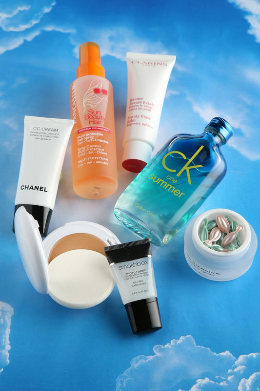 Cosmetics and beauty products are arranged on a blue background