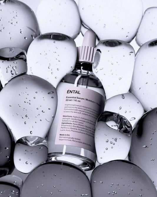 A bottle of serum surrounded by clear, rounded shapes.