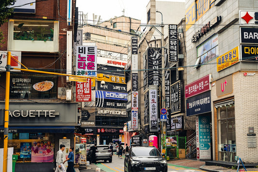 Busy street with many signs and cars in city.