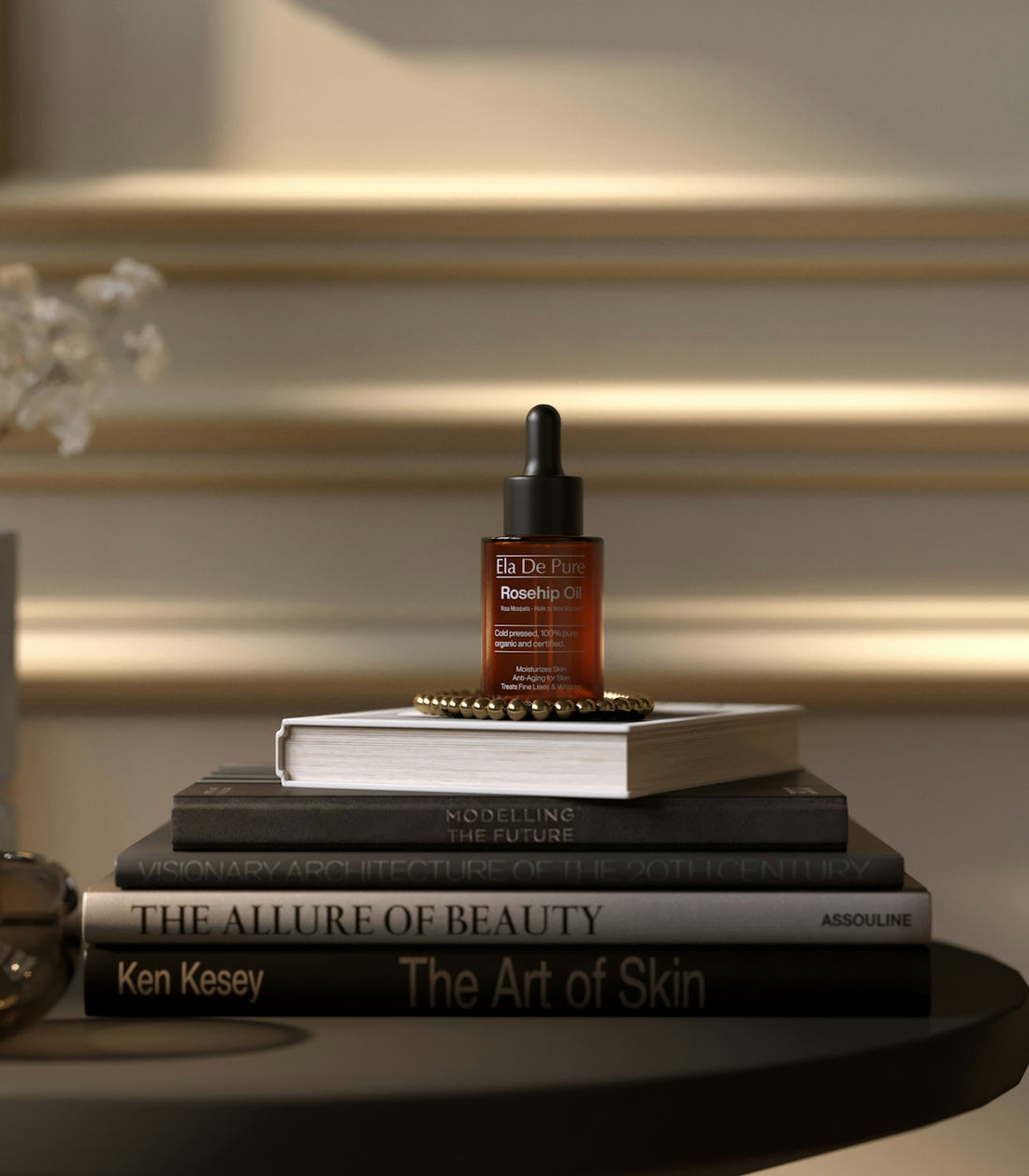 A bottle of serum sits on a stack of books.